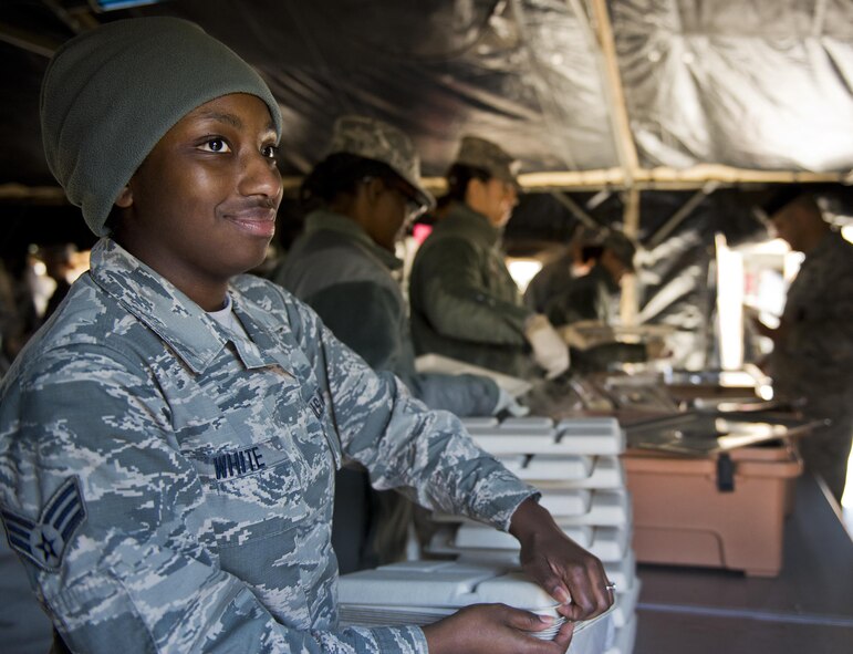 Senior Airman Brianna White, 919th Special Operations Force Support Squadron, hands out plates to customers in the unit’s field kitchen Feb. 7 at Duke Field Fla.  The kitchen was erected and used as part of the 919th SOFSS flight’s Hennessy Award inspection.  The Airmen cooked and served lunch to customers from the constructed kitchen.  (U.S. Air Force photo/Tech. Sgt. Jasmin Taylor)