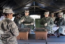 Staff Sgt. Molly Holzem, 919th Special Operations Force Support Squadron, prepares a plate for a customer in the unit’s field kitchen Feb. 7 at Duke Field Fla.  The kitchen was erected and used as part of the 919th SOFSS flight’s Hennessy Award inspection.  The Airmen cooked and served lunch to customers from the constructed kitchen.  (U.S. Air Force photo/Tech. Sgt. Jasmin Taylor)