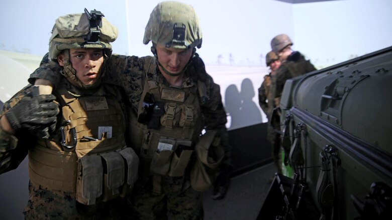 Marines with 5th Battalion, 11th Marine Regiment, 1st Marine Division, carry Marines to their designated vehicle in a Combat Convoy Simulator at Marine Corps Base Camp Pendleton, California, Feb. 2, 2016. The CCS at first glance may look like a really expensive, high-tech video game but its primary use is preparing Marines for real-world combat missions with inexpensive simulations of realistic scenarios.