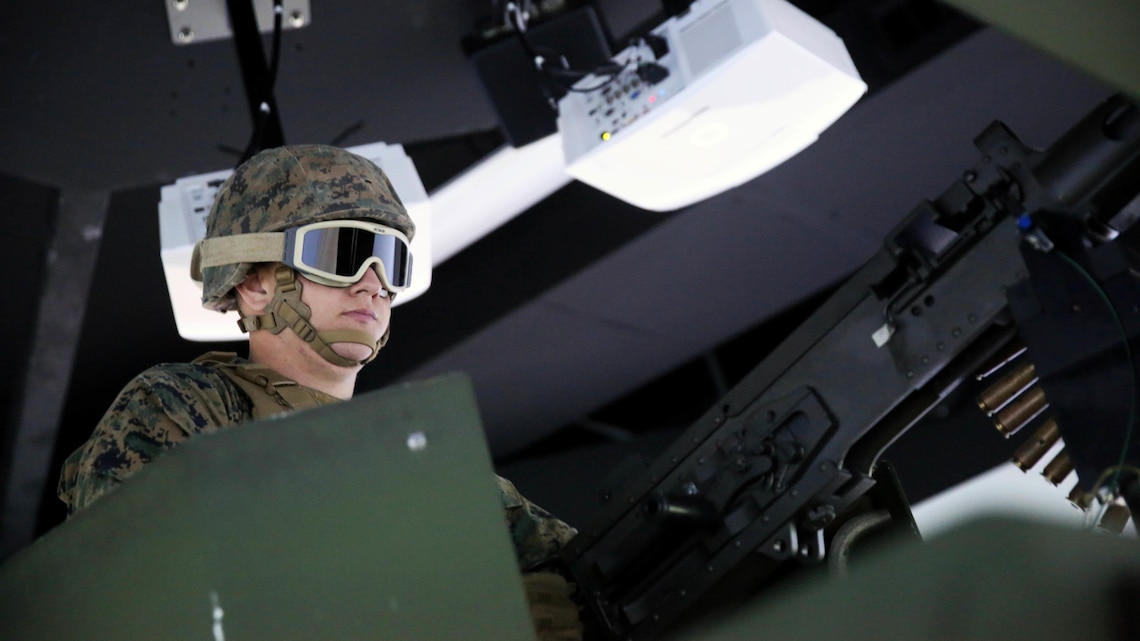 A Marine with 5th Battalion, 11th Marine Regiment, 1st Marine Division, loads an electronic M2 .50-caliber machine gun in a Combat Convoy Simulator at Marine Corps Base Camp Pendleton, California, Feb. 2, 2016. The CCS at first glance looks like an expensive, high-tech video game, but its primary use is preparing Marines for real-world combat missions with simulations of realistic scenarios.