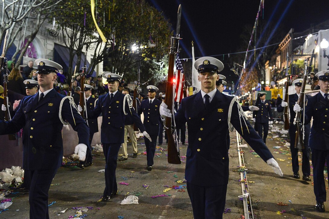 Members of the Coast Guard's ceremonial honor guard perform a rifle routine while marching during the Bacchus Mardi Gras parade in New Orleans, Feb. 7, 2016. The honor guard participates in multiple military events around the country. Coast Guard photo by Petty Officer 2nd Class Jonathan Lally