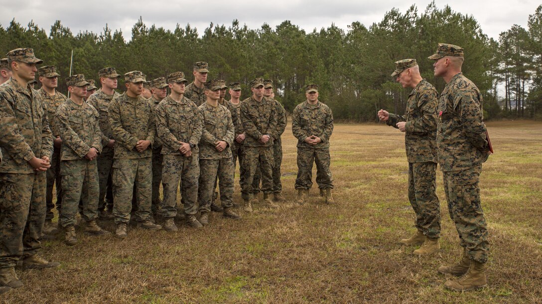 Major Gen. Brian D. Beaudreault, the commanding general of 2nd Marine Division, speaks to Marines at Marine Corps Base Camp Lejeune, North Carolina, Feb. 5, 2016, as Staff Sgt. Nathan A. Hervey, an instructor with the Advanced Infantry Training Battalion at the School of Infantry-East, looks on. Hervey was awarded the Bronze Star Medal with the combat distinguishing device for valor, and was recognized for extraordinary heroism for his actions on May 21, 2011, while carrying out his duties as a scout sniper section leader with 3rd Battalion, 2nd Marine Regiment, in support of Operation Enduring Freedom. 