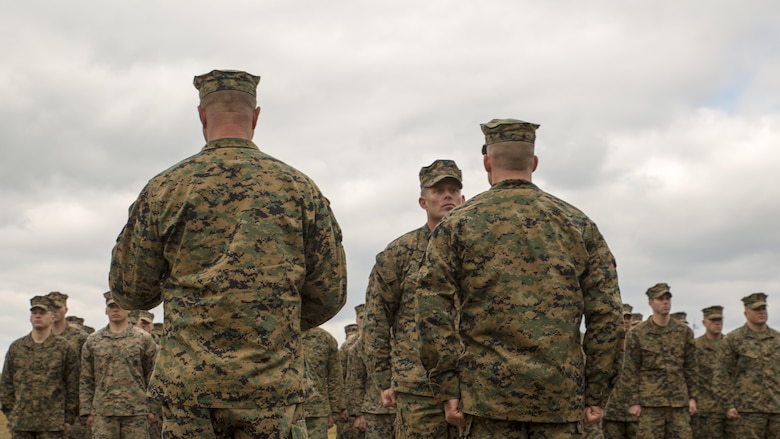Staff Sgt. Nathan A. Hervey, an instructor with the Advanced Infantry Training Battalion at the School of Infantry-East, listens to his award citation being read at Marine Corps Base Camp Lejeune, North Carolina, Feb. 5, 2016. Hervey was awarded the Bronze Star Medal with the combat distinguishing device for valor, and was recognized for extraordinary heroism for his actions on May 21, 2011, while carrying out his duties as a scout sniper section leader with 3rd Battalion, 2nd Marine Regiment, in support of Operation Enduring Freedom.