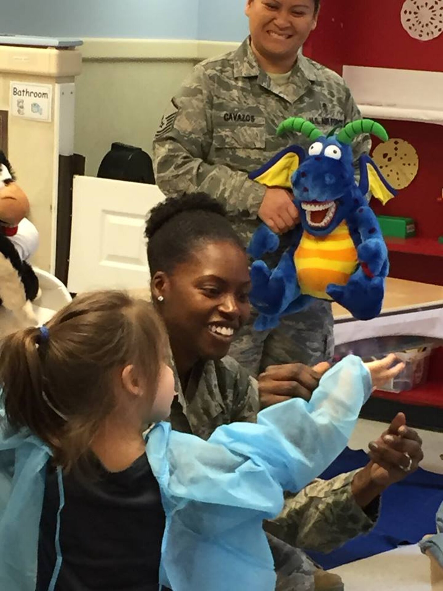 On Feb. 5, members of the Dental Squadron from the 779th Medical Group went to the Child Development Center on Joint Base Andrews to teach the kids about good dental health. Tech. Sgt. Tina Phelps-Prince, NCOIC for preventive dentistry, helped one member of the class to dress up as a dentist. (AF photo by Melanie Moore/Released) 