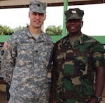 Lt. Col. William LeCates, a New York Army National Guard doctor, stands with Capt. Joseph Kowo, deputy commander of the Armed Forces of Liberia Medical Command, during his 2015 deployment to Liberia as part of Operation Onward Liberty, a mission conducted by the Michigan Army National Guard. LeCates, who works as a civilian doctor in Cooperstown, New York, was deployed in Liberia for six months as part of the training and mentoring mission. 