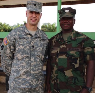 Lt. Col. William LeCates, a New York Army National Guard doctor, stands with Capt. Joseph Kowo, deputy commander of the Armed Forces of Liberia Medical Command, during his 2015 deployment to Liberia as part of Operation Onward Liberty, a mission conducted by the Michigan Army National Guard. LeCates, who works as a civilian doctor in Cooperstown, New York, was deployed in Liberia for six months as part of the training and mentoring mission. 