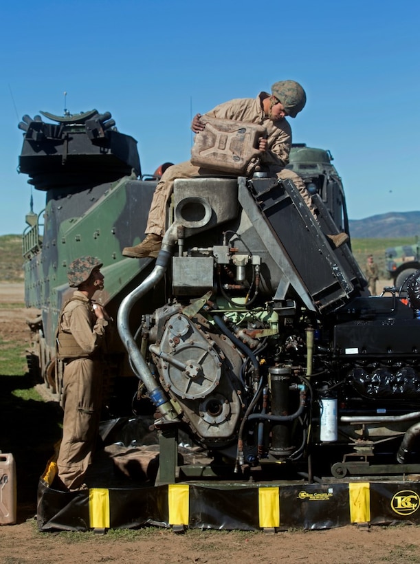 MARINE CORPS BASE CAMP PENDLETON, Calif. – Pfc. Celso Romero watches Lance Cpl. Salgado Chavez as he pours water into an assault amphibious vehicle engine at Camp Pendleton, Feb. 2, 2016. 3rd Assault Amphibious Battalion provides forward maintenance capabilities and allow for immediate restoration of AAVs that break down. Romero, from Fresno is an AAV driver with Company A., 3rd AAB. Chavez, from Seattle, Wash. is an AAV crewman with Co. A., 3rd AAB. (U.S. Marine Corps Photo by Lance Cpl. Justin E. Bowles)