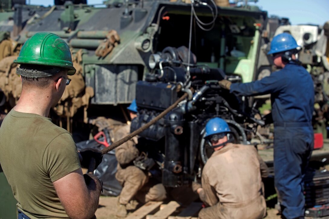 MARINE CORPS BASE CAMP PENDLETON, Calif. – Marines with Company A., 3rd Assault Amphibious Battalion conduct maintenance on an Assault Amphibious Vehicle engine at Camp Pendleton, Feb. 2, 2016. Marines from 3rd AAB supported 2nd Battalion, 4th Marine Division and 1st Bn, 1st Mar. Div. infantry battalions as they conducted raid drills for Expeditionary Operations Training Group and their Marine Corps Combat Readiness Evaluation. “We are being mechanics, changing engines, changing transmissions and troubleshooting issues so we can get the infantry units back in the fight with the full power of their AAVs,” said Staff Sgt. Nicholas R. Faltynski, recovery chief for Company A., 3rd AAB. (U.S. Marine Corps Photo by Lance Cpl. Justin E. Bowles)