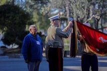 Retired Marine Sgt. Maj. Martin Vasquez (left) and Maj. Gen. Daniel J. O’Donohue, commanding general of the 1st Marine Division, attach campaign streamers to the division colors during a Battle Colors Rededication Ceremony in honor of the division’s 75th anniversary, aboard Marine Corps Base Camp Pendleton, Calif., Feb. 4, 2016.  Veteran and active duty Marines and Sailors who served in the division over the years participated in the ceremony, celebrating the oldest, largest, and most decorated division in the Marine Corps. (U.S. Marine Corps photo by Cpl. Will Perkins)
