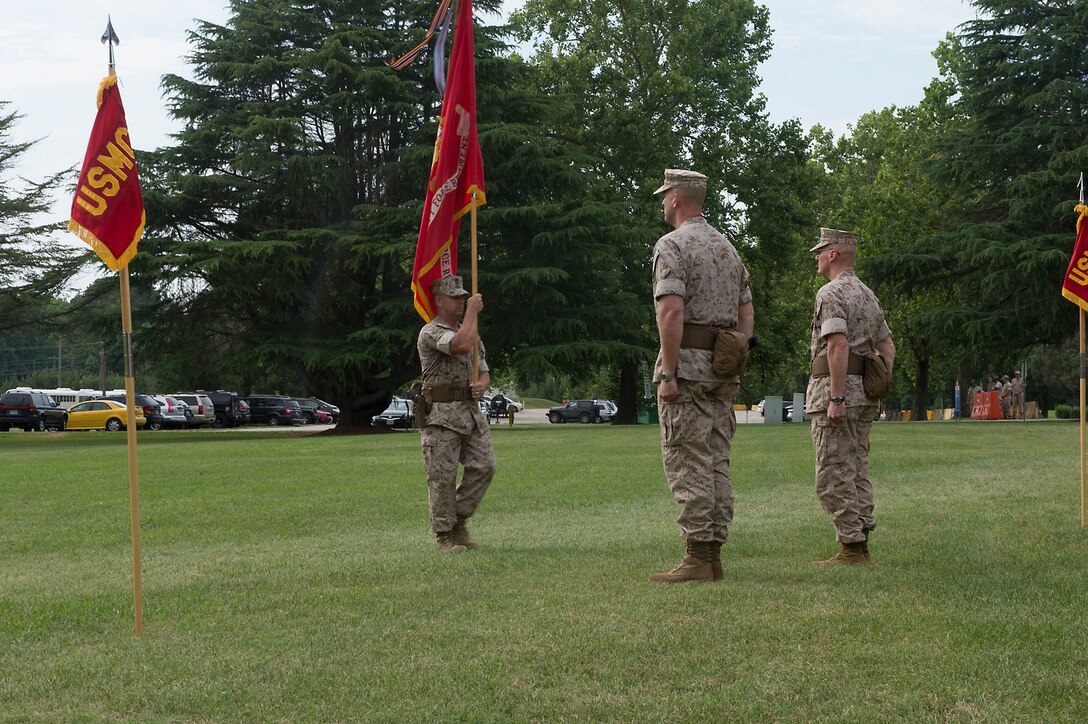 U.S. Marine Col. James W. Evans (left) and U.S. Marine Col. James M. Bright await the change of colors during the change-of-command ceremony June 19 at Naval Weapons Station Yorktown, Va. The exchanging of regimental colors represents the passing of command from the outgoing commanding officer to the incoming commanding officer.