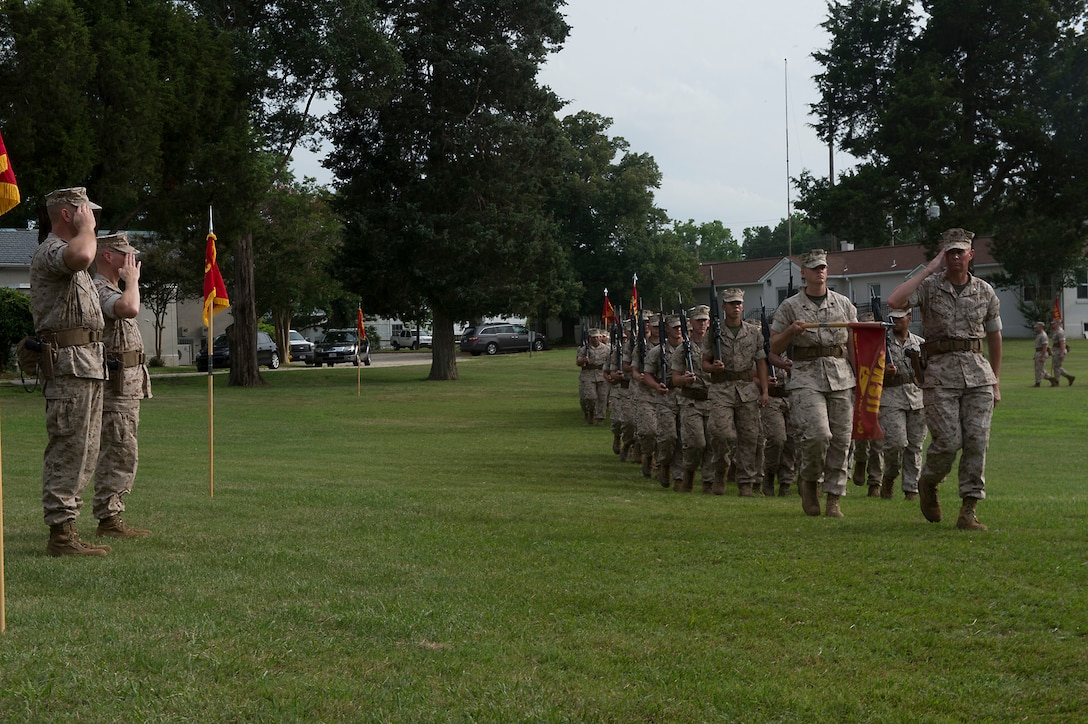 U.S. Marine Col. James W. Evans (left) and U.S. Marine Col. James M. Bright salute the companies of the Marine Corps Security Force Regiment during the pass and review at a change-of-command ceremony June 19 at Naval Weapons Station Yorktown, Va. The Marine Corps Security Force Regiment is the Marine Corps’ largest regiment with over 4,000 Marines and sailors spread across the globe.