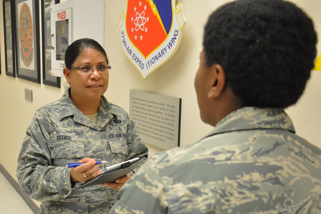 Master Sgt. Janine Obando, 379th Air Expeditionary Wing Equal Opportunity specialist from Ewa, Hawaii, meets with Staff Sgt. Yolanda Jackson, 379 AEW Protocol noncommissioned officer in charge from Chicago,  at the Wing Operations Center at Al Udeid Air Base, Qatar, Jan. 21. Obando said it's important for her to meet with service members across AUAB to foster trust between units and the EO office. Jackson and Obando discussed different aspects of the protocol mission during the meeting. (U.S. Air Force photo by Tech. Sgt. James Hodgman/Released)