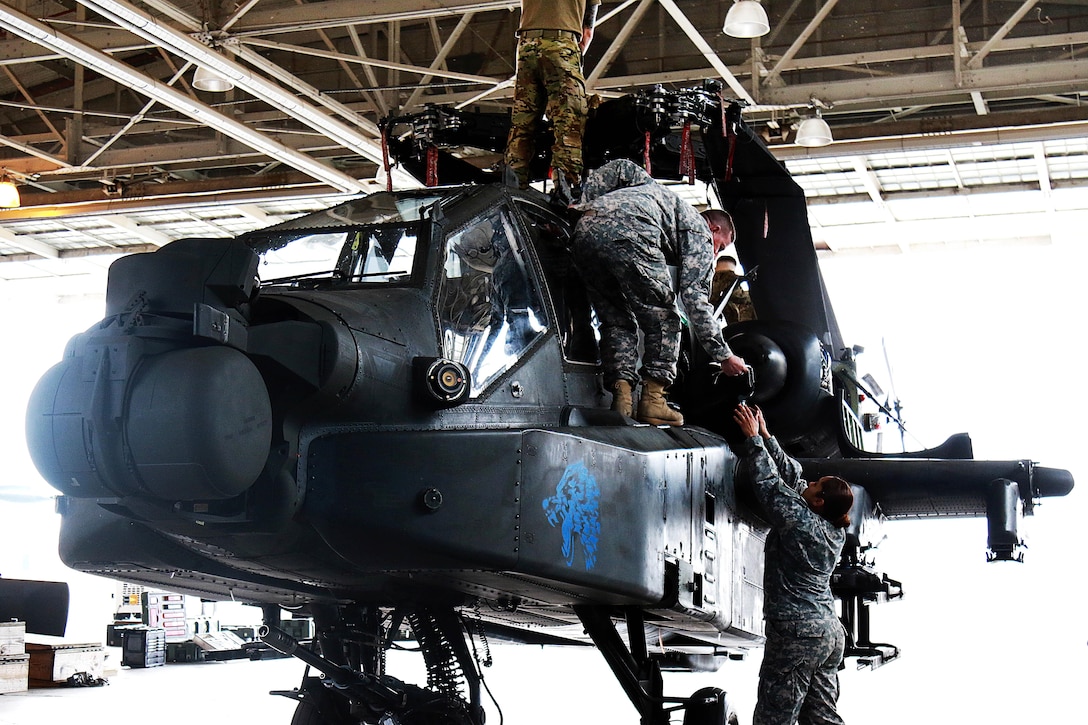 Soldiers prepare an AH-64 Apache helicopter for transport at Fort Bragg, N.C., Feb. 2, 2016. The soldiers are assigned to the 122nd Aviation Support Battalion, 82nd Combat Aviation Brigade. The breakdown of the aircraft is critical for bringing aviation support to the ground forces commander of the global response force. Army photo by Staff Sgt. Christopher Freeman