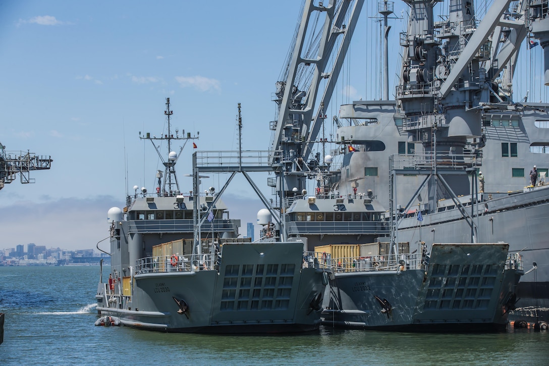 Two Landing Craft Utility 2000's from the 481st Transportation Company (Heavy Boats) are tied alongside a Naval Cargo ship at Alameda Point, Calif. on July 30, 2015. Army Reserve crews sailed both boats for 36 hours up the California coast from Port Hueneme to conduct harbor and seaport operations training at the Big Logistics Over The Shore, West exercise at Alameda Point, Calif., from July 25 to Aug. 7, 2015.