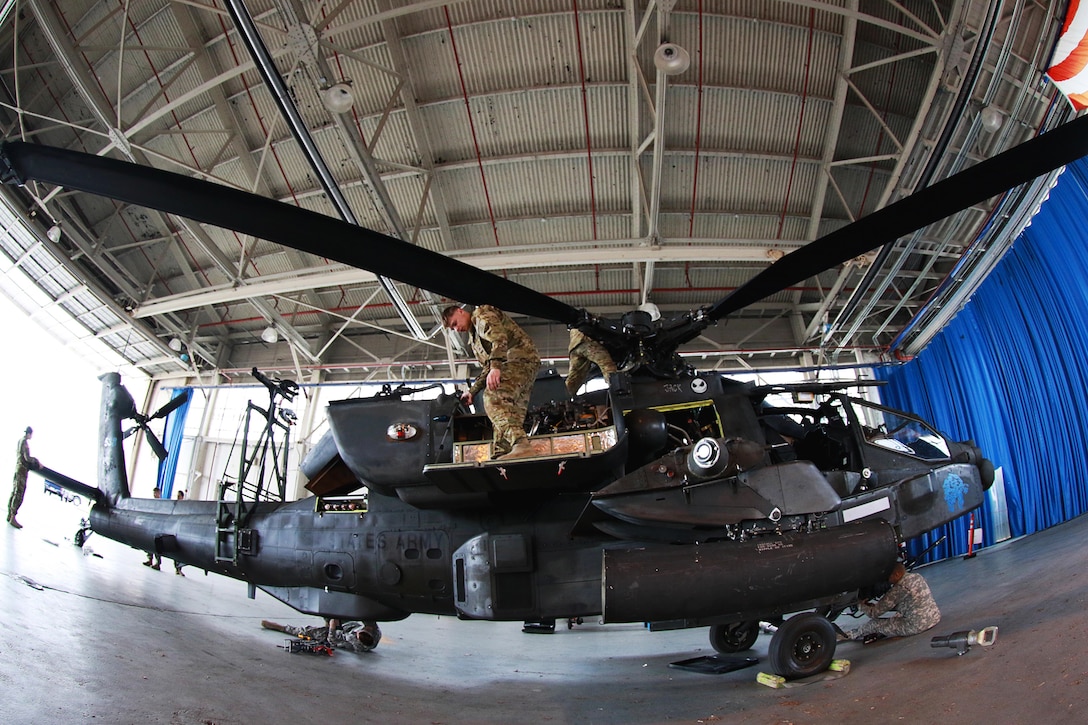 Soldiers prepare an AH-64 Apache helicopter for transport at Fort Bragg, N.C., Feb. 2, 2016. Army photo by Staff Sgt. Christopher Freeman