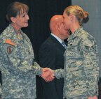 Command Sgt. Maj. Kimberly Kemper, commandant of the Army’s Noncommissioned Officer Academy located on Joint Base McGuire-Dix-Lakehurst, N.J., left, congratulates Air Force Senior Airman Jordan Lamb of the 621st Contingency Response Squadron upon her graduation Jan. 28 from the academy.