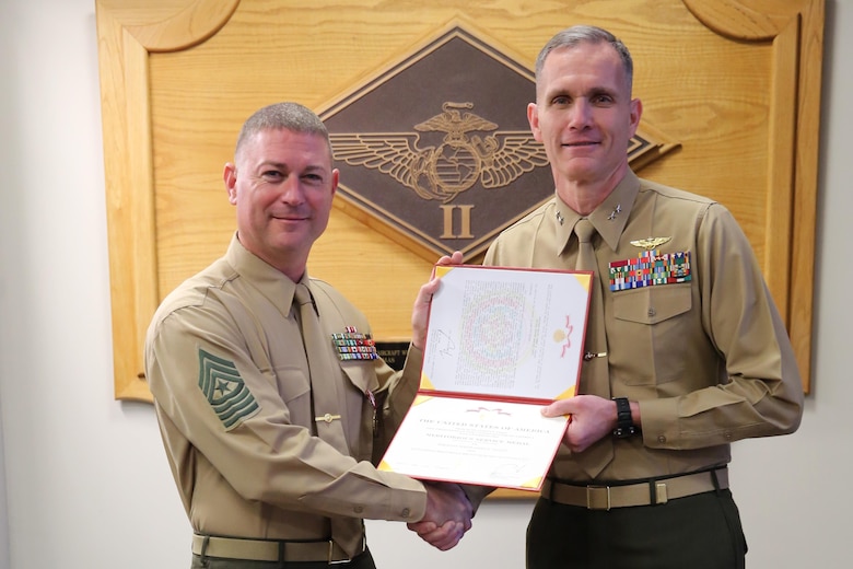 Sergeant Maj. James D. Vealey stands with Maj. Gen. Gary L. Thomas after being awarded the Meritorious Service Medal for outstanding meritorious service while serving as Sergeant Major of Combat Logistics Battalion 3, Combat Logistics Regiment 3, 3rd Marine Logistics Group, III Marine Expeditionary Force from May 2013 – July 2015 during a ceremony at Marine Corps Air Station Cherry Point, Jan 8. Vealey is the sergeant major of Marine Wing Headquarters Squadron 2, and Thomas is the commanding general of 2nd Marine Aircraft Wing.(U.S. Marine Corps Photo by Sgt. Grace L. Waladkewics/Released)
