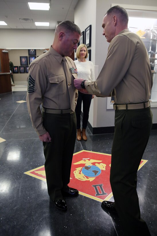 Maj. Gen. Gary L. Thomas (right) pins a Meritorious Service Medal on Sergeant Maj. James D. Vealey following the presentation of his award for outstanding meritorious service while serving as Sergeant Major of Combat Logistics Battalion 3, Combat Logistics Regiment 3, 3rd Marine Logistics Group, III Marine Expeditionary Force from May 2013 – July 2015 during a ceremony at Marine Corps Air Station Cherry Point, Jan 8. Thomas is the commanding general of 2nd Marine Aircraft Wing, and Vealey is the sergeant major of Marine Wing Headquarters Squadron 2. (U.S. Marine Corps Photo by Sgt. Grace L. Waladkewics/Released)