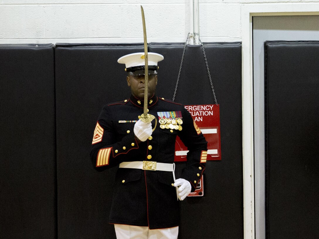 Gunnery Sgt. Kowayne Pressley, radio chief, Headquarters and Service Company, returns sword during the 2016 parade staff tryouts at Marine Barracks Washington, D.C., Feb. 9, 2016. The evaluation selects the most qualified Marines of “the Oldest Post of the Corps” for this year’s upcoming parade season as well as assignments for ceremonies and other related events. (Official Marine Corps photo by Cpl. Chi Nguyen/Released)