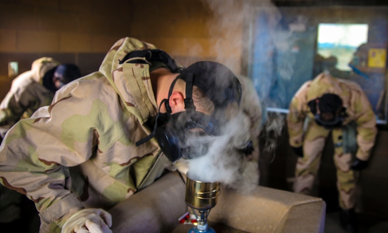 Cpl. Austin Castleman, a chemical, biological, radiological and nuclear (CBRN) specialist with Marine Aircraft Group 13, ensures the burner is effectively producing Chlorobenzalmalononitrile (CS) gas during Marine Aircraft Group 13 (MAG -13) Headquarters bi-annual CBRN certification class held at the gas chamber aboard Marine Corps Air Station Yuma, Ariz., Thursday, Jan. 28, 2016.