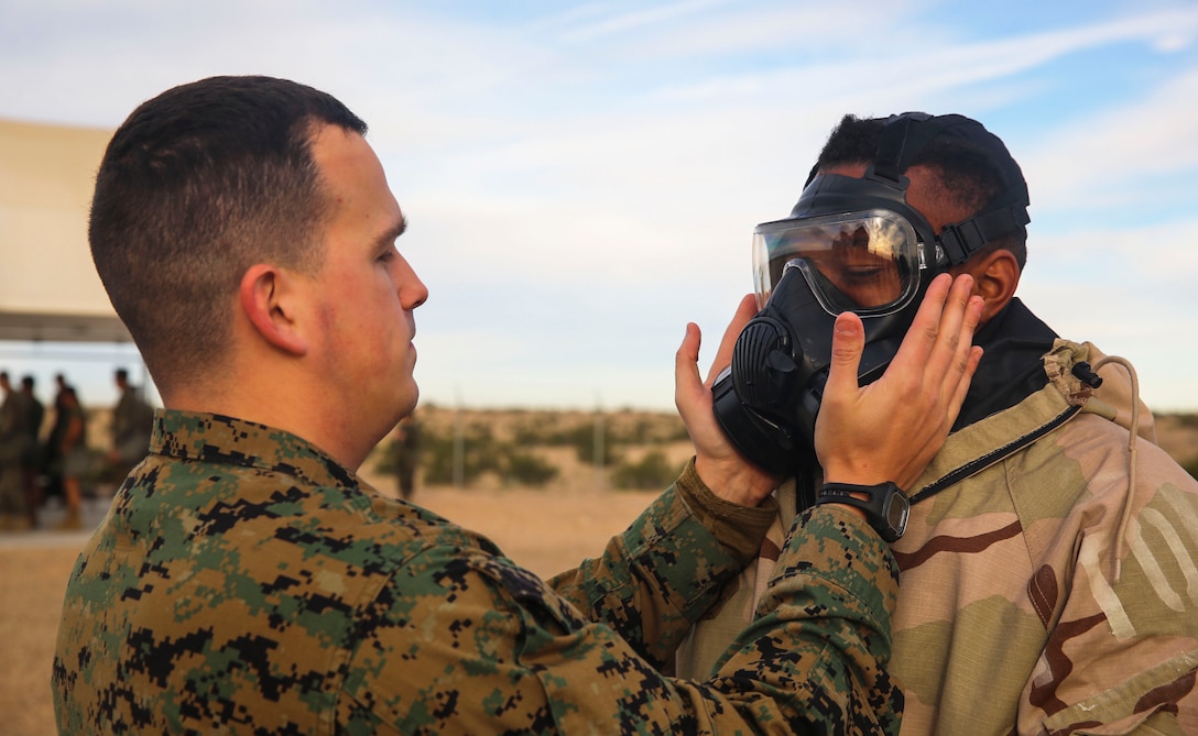 Staff Sgt. Christopher Moen, the chemical, biological, radiological and nuclear (CBRN) staff non-commissioned officer-in-charge ensures each Marines gas mask is in working order before training begins during Marine Aircraft Group 13 (MAG -13) Headquarters bi-annual CBRN certification class, held at the gas chamber aboard the training area at MCAS Yuma, Ariz., Thursday, Jan. 28, 2016.