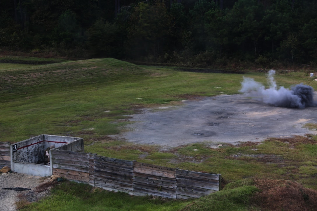 Marines brace for a detonation during a grenade and MK-19 Grenade Launcher range at Marine Corps Base Camp Lejeune, N.C., Oct. 28, 2015. More than 70 Marines with 2nd Low Altitude Air Defense Battalion took turns handling the MK19 and handheld grenades during the familiarization range. The range offered Marines the opportunity to build confidence and proficiency skills on some of the crew-served weapons they operate while providing security in a deployed environment. (U.S. Marine Corps photo by Cpl. N.W. Huertas/Released)