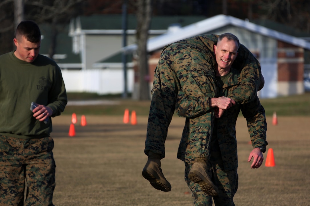 Maj. Gen. Gary Thomas fireman carries his partner through a field during a combat fitness test at Marine Corps Air Station Cherry Point, N.C., Dec. 4, 2015. The CFT is an annual requirement for all Marines to assess their physical capacity in a broad spectrum of combat-related tasks. 2nd MAW Marines maintain their combat readiness year-round in order to provide continuous support to the Marine Air-Ground Task Force. (U.S. Marine Corps photo by Cpl. N.W. Huertas/Released)