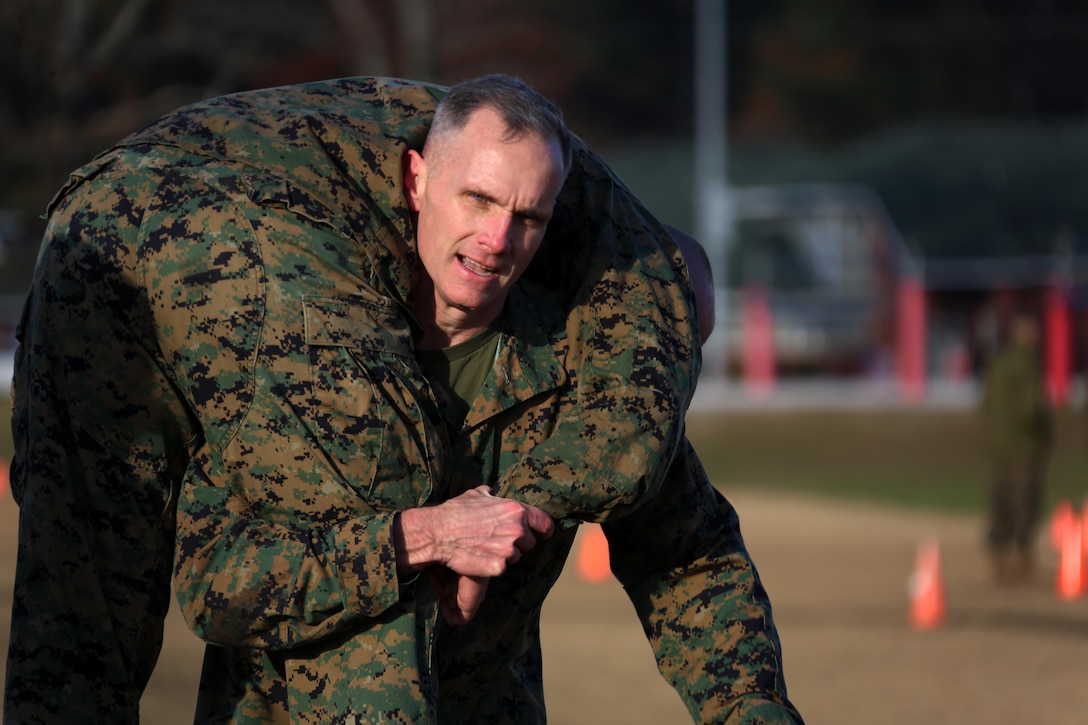 The 2nd Marine Aircraft Wing Commanding General, Maj. Gen. Gary L. Thomas carries his partner during a combat fitness test at Marine Corps Air Station Cherry Point, N.C., Dec. 4, 2015. The CFT is an annual requirement for all Marines to assess their physical capacity in a broad spectrum of combat-related tasks. 2nd MAW Marines maintain their combat readiness year-round in order to provide continuous support to the Marine Air-Ground Task Force. (U.S. Marine Corps photo by Cpl. N.W. Huertas/Released)
