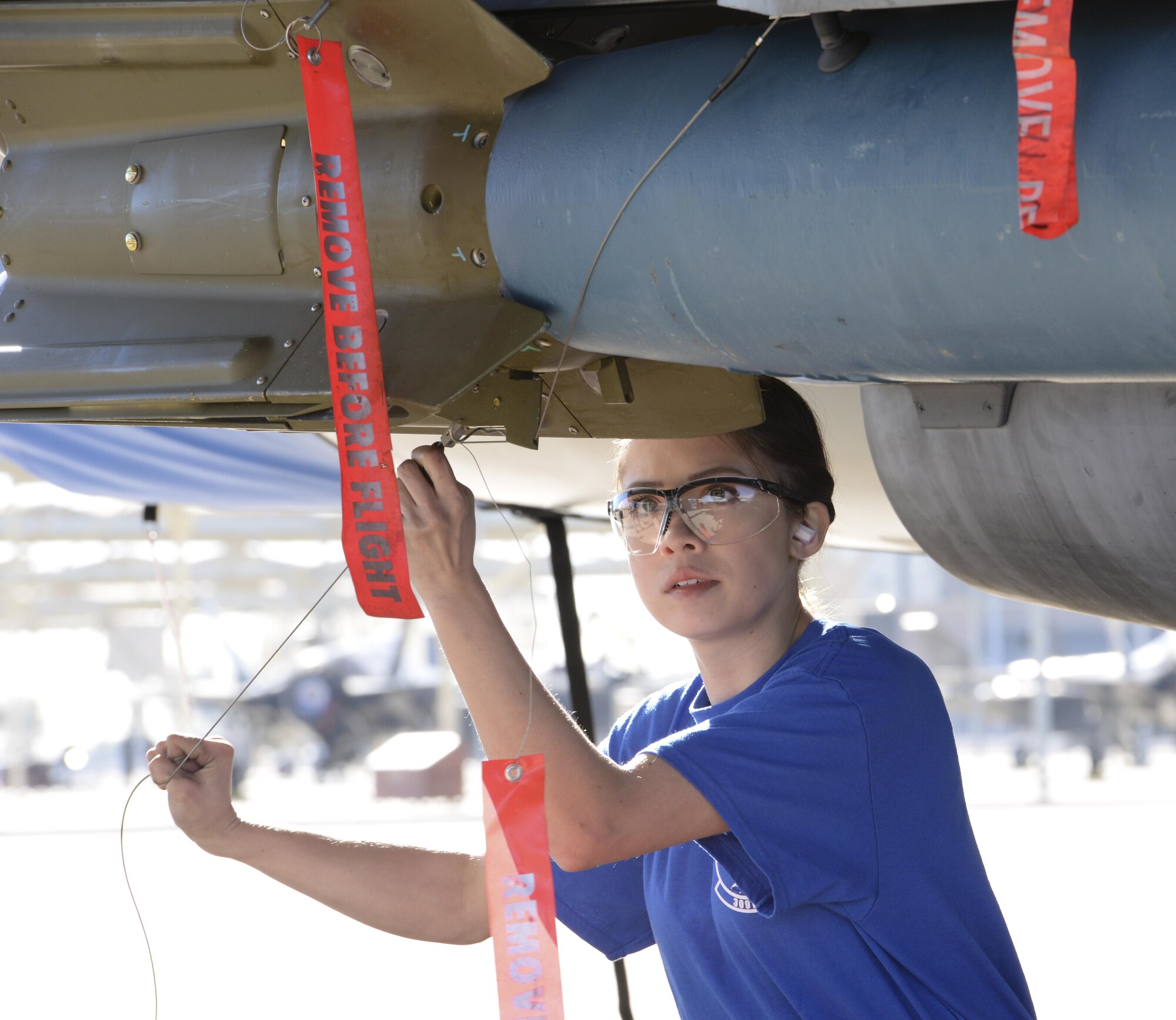Airman 1st Class Nadiya Frick, 309th Aircraft Maintenance Unit load crew member, secures a weapon during the competition. Knowledge and communication were tools essential to the success of competing teams. (U.S. Air Force photo by Airman 1st Class Ridge Shan)