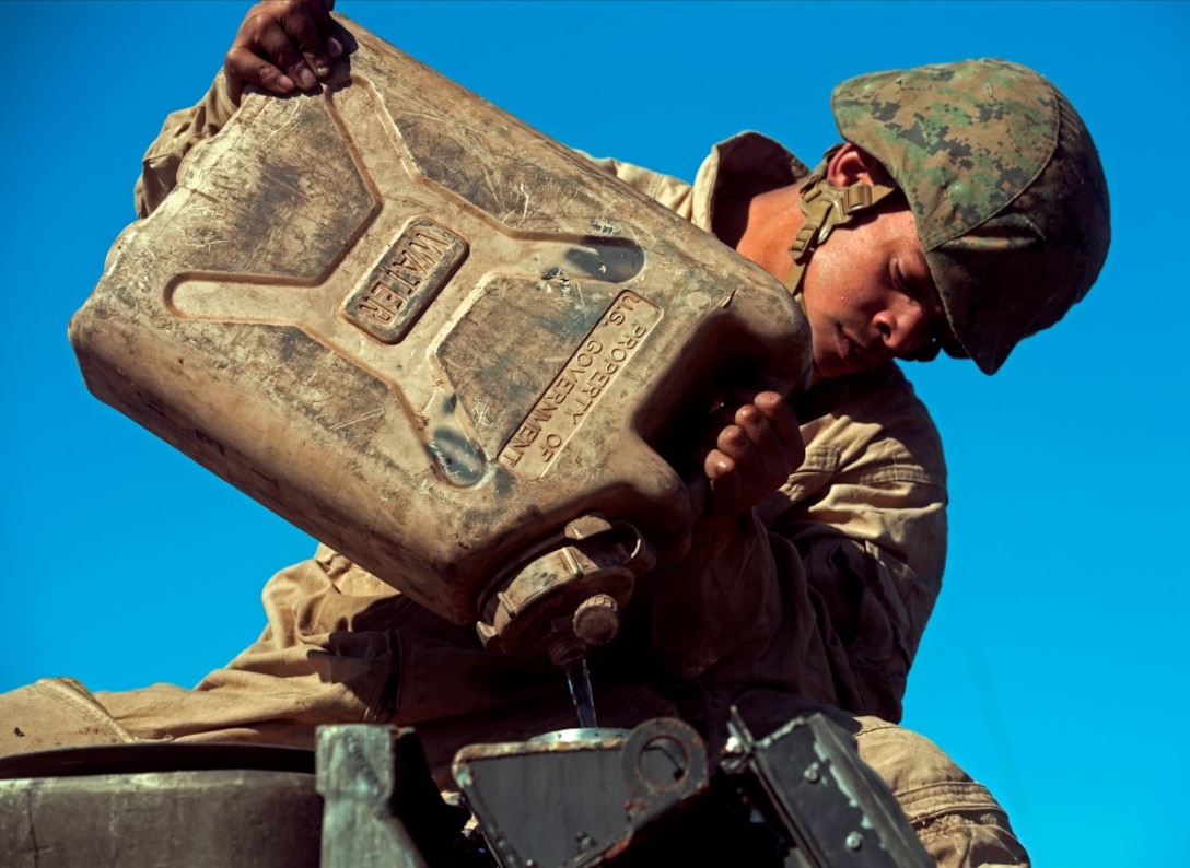 MARINE CORPS BASE CAMP PENDLETON, Calif. – Lance Cpl. Salgado Chavez checks for leaks by pouring water into the radiator of an Assault Amphibious Vehicle engine at Camp Pendleton, Feb. 2, 2016. Marines from 3rd Amphibious Assault Battalion supported 2nd Bn, 4th Marine Division and 1st Bn, 1st Mar. Div. infantry battalions as they conducted raid drills for Expeditionary Operations Training Group and their Marine Corps Combat Readiness Evaluation. As an Assault Amphibious Vehicle crewman, Chavez’ duties include driving, maintaining and inspecting his AAV. Chavez, from Seattle, Wash. is an AAV crewman with Company A., 3rd AAB, 1st Marine Division (U.S. Marine Corps Photo by Lance Cpl. Justin E. Bowles)