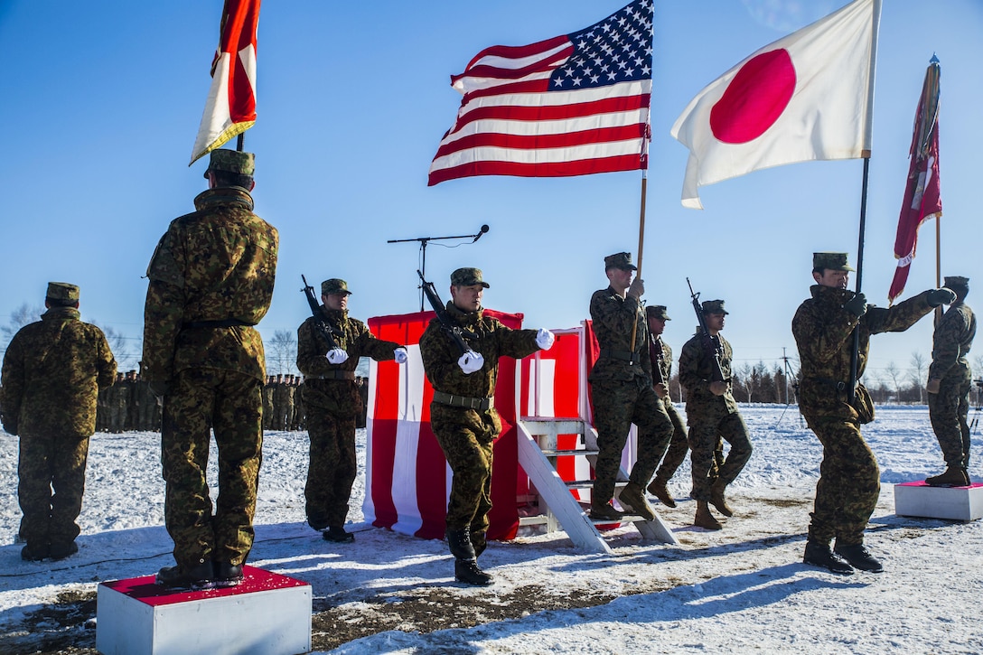 U.S. Marines and Japan Ground Self-Defense Force Soldiers retire the colors during the opening ceremony of Forest Light 16-2 in Yausubetsu Training Area, Hokkaido, Japan, Jan. 26, 2016. Forest Light, which concluded Feb. 6, is a semi-annual exercise between Japan and the U.S. The exercise strengthens military partnership, solidifies regional security agreements and improves individual and unit-level skills. The JGSDF members are with the 27th Infantry Regiment, 5th Brigade, Northern Army. The Marines are with 3rd Battalion, 5th Marine Regiment, currently assigned to 4th Marine Regiment, 3rd Marine Division, III Marine Expeditionary Force. (U.S. Marine Corps Photo by Cpl. Tyler S. Giguere/Released)