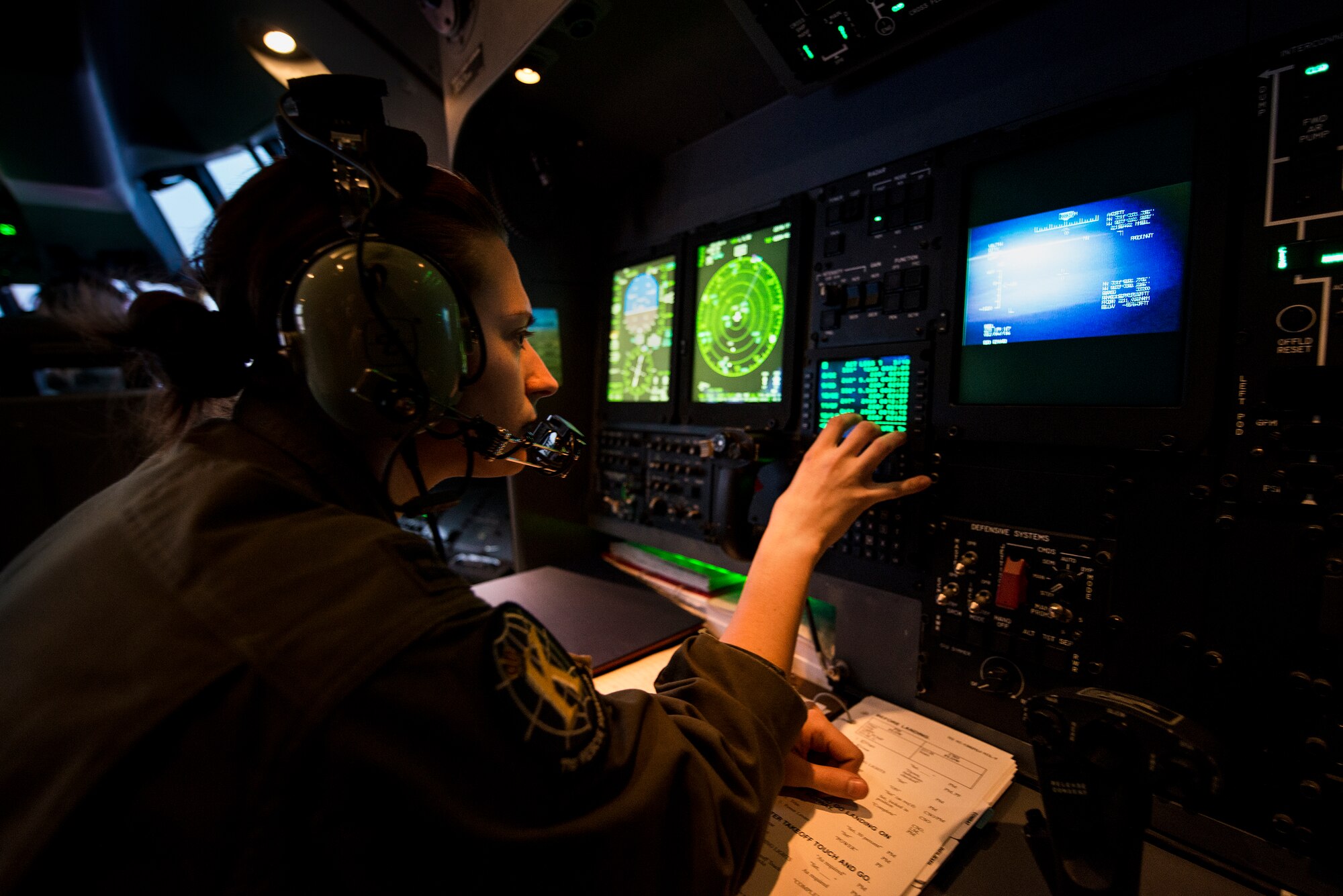 U.S. Air Force Capt. Ashley Mayes, 71st Rescue Squadron combat systems officer, performs duties on board an HC-130J Combat King II, Feb. 4, 2016 in the skies over Moody Air Force Base, Ga. Combat systems officers rely on a wide range of high-tech equipment and weaponry to provide navigation and weapons systems support to accomplish their missions. (U.S. Air Force photo by Senior Airman Ryan Callaghan/Released)




