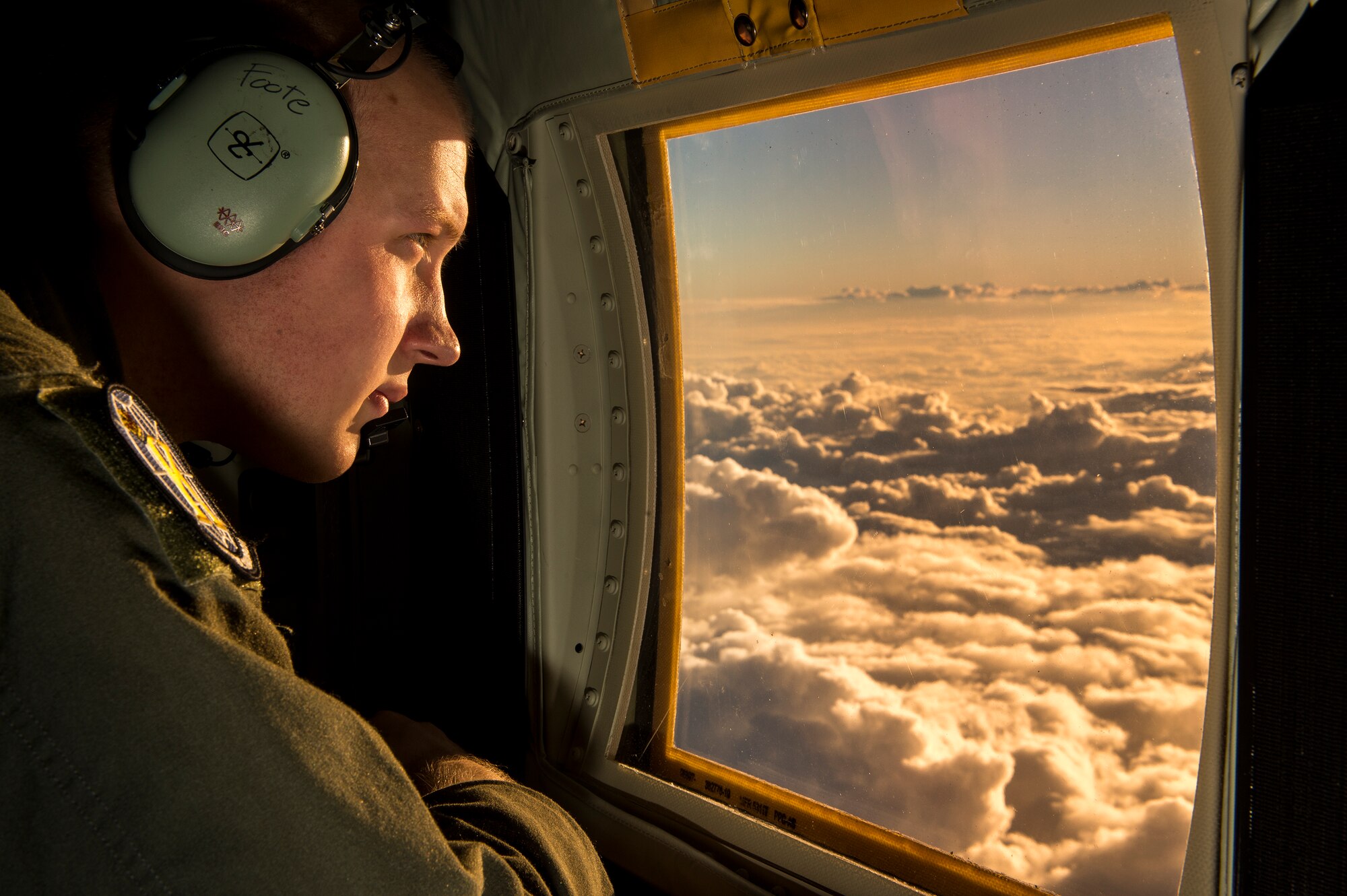 U.S. Air Force Senior Airman Timothy Foote, 71st Rescue Squadron loadmaster, looks out the window of an HC-130J Combat King II, Feb. 2, 2016 in the skies over Moody Air Force Base, Ga. The HC-130J can fly in the day, however, crews normally fly night missions at low to medium altitude levels in contested or sensitive environments, both over land or over water. (U.S. Air Force photo by Senior Airman Ryan Callaghan/Released)


