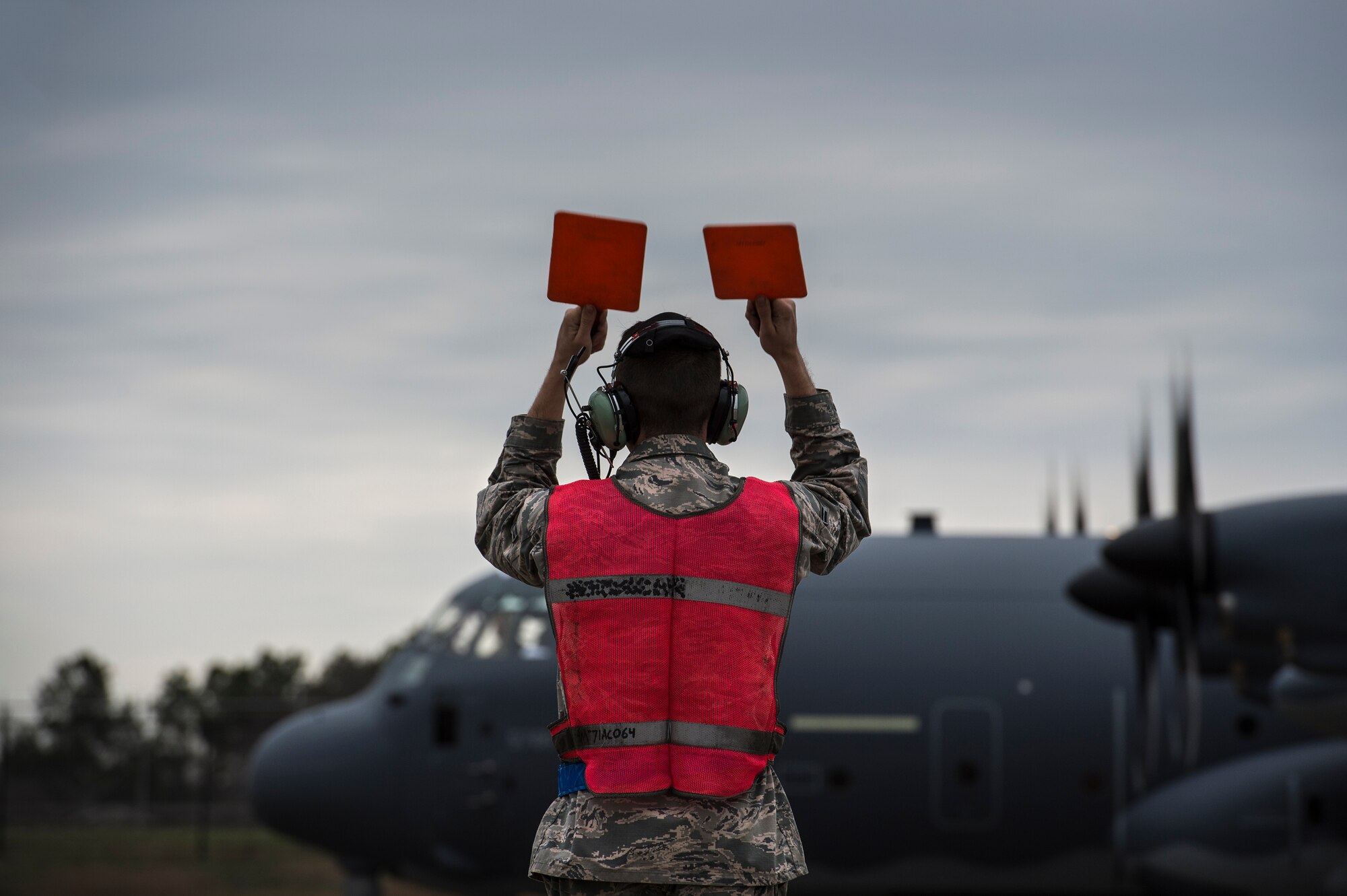 A U.S. Air Force Airman from the 71st Aircraft Maintenance Unit marshals an HC-130J Combat King II to a parking spot, Feb. 4, 2016, at Moody Air Force Base, Ga. The HC-130J can fly in the day, however, crews normally fly night missions at low to medium altitude levels in contested or sensitive environments, both over land or over water. (U.S. Air Force photo by Senior Airman Ryan Callaghan/Released)
