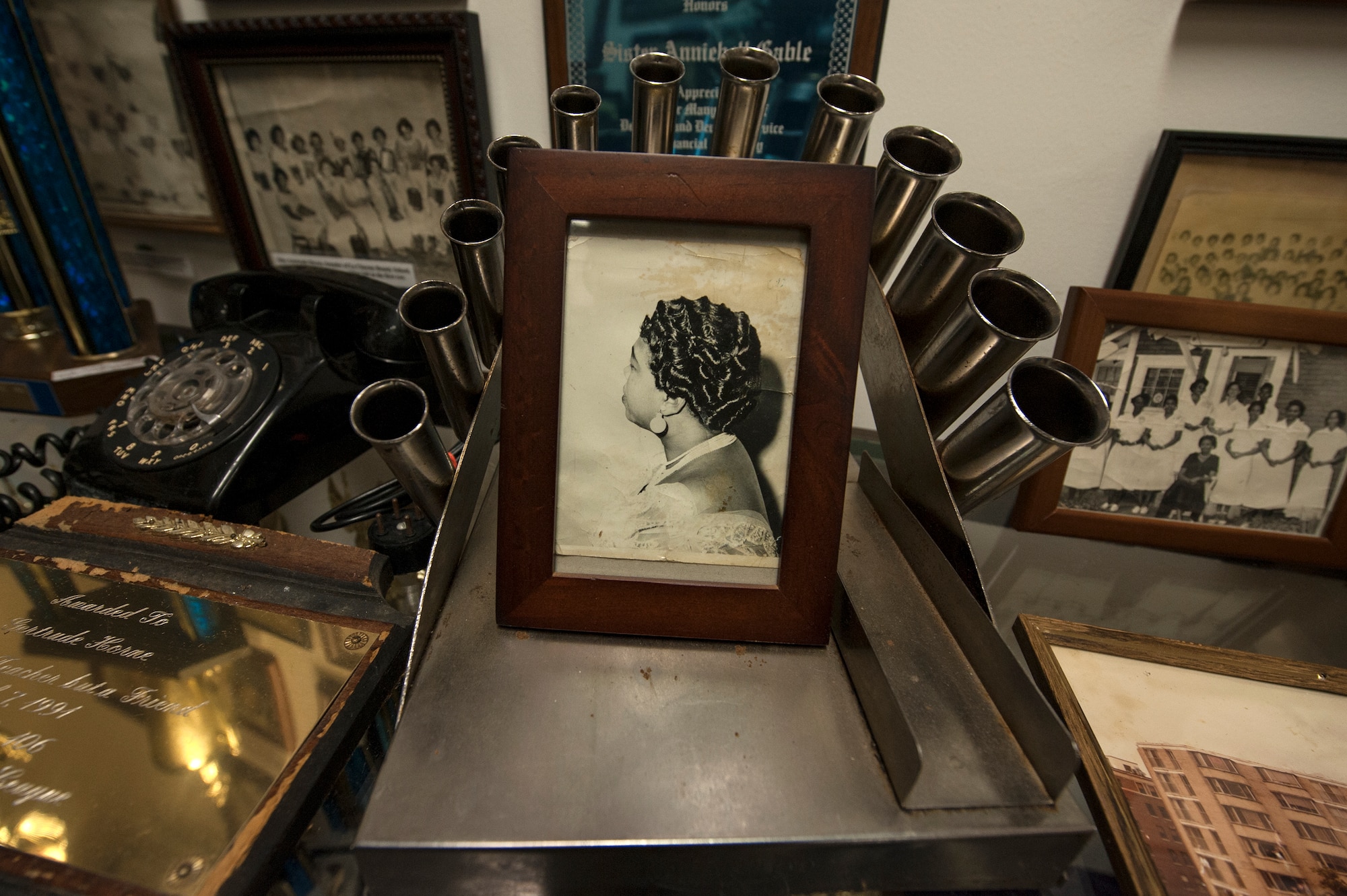 An antique curling iron holder and a photo of a finished hairstyle rest on a display case Feb. 8, 2016, at the Jack Hadley Black History Museum in Thomasville, Ga. The Cosmetology and La Charme Beauty and Culture School section of the museum showcases innovations and accomplishments made by black barbers and beauticians from Thomasville, Ga. (U.S. Air Force photo by Airman 1st Class Janiqua P. Robinson/Released)
