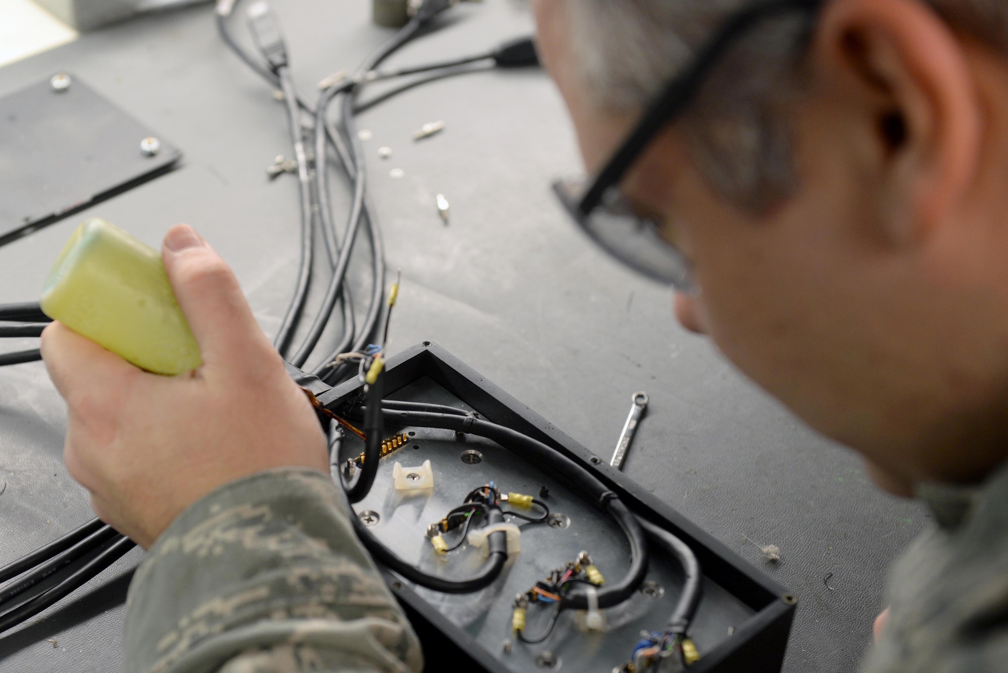 Tech. Sgt. Darrel Rhodes, 4th Maintenance Group Air Force Repair Enhancement Program technician, solders a Removable Memory Module Reader, Feb. 5, 2016, at Seymour Johnson Air Force Base, North Carolina. An RMM reader is used for storing and retrieving programs and data. (U.S. Air Force photo/ Airman 1st Class Ashley Williamson)