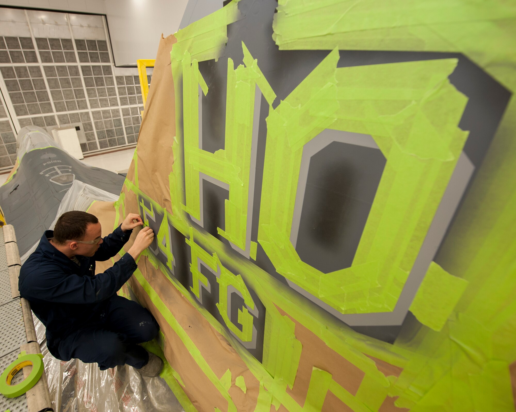 Senior Airman Paul Gatlin, an aircraft structural maintenance technician with the 49th Maintenance Squadron, finishes taping off the vertical stabilizer of the 54th Squadron’s F-16 Flagship inside one of three paint booths at Holloman Air Force Base, New Mexico, on Nov. 10. Corrosion control specialists have the unique task of ensuring every aircraft on base is able to withstand deterioration caused by the weather. (U.S. Air Force photo by Airman 1st Class Randahl J. Jenson)