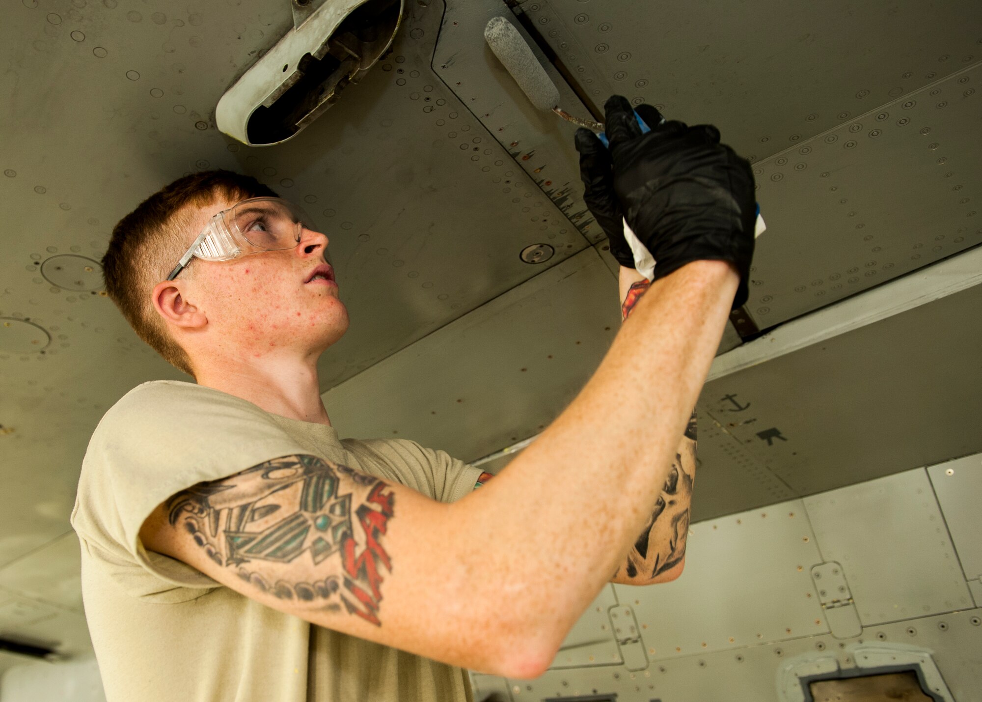 Airman 1st Class Logan Jackson, an aircraft structural maintenance technician with the 49th Maintenance Squadron, touches up the bottom of an F-16 Fighting Falcon with paint at Holloman Air Force Base, New Mexico, on Nov. 10, to prevent deterioration. Technicians like Jackson are responsible for the upkeep of aircraft when it comes to preventing corrosion. (U.S. Air Force photo by Airman 1st Class Randahl J. Jenson) 