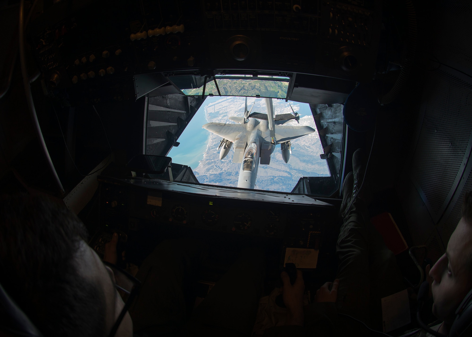 Senior Airman Joel Perez, 6th Air Refueling Squadron boom operator, left, refuels an F-15C Eagle as Senior Airman Cory Peterson, 6th Air Refueling Squadron instructor boom operator, right, observes the refuel operations Feb. 7, 2016, above the skies of Santa Clara, California. The refueling mission was in direct support of fighter aircraft patrolling the airspace surrounding Super Bowl 50. (U.S. Air Force photo T.C. Perkins Jr.)