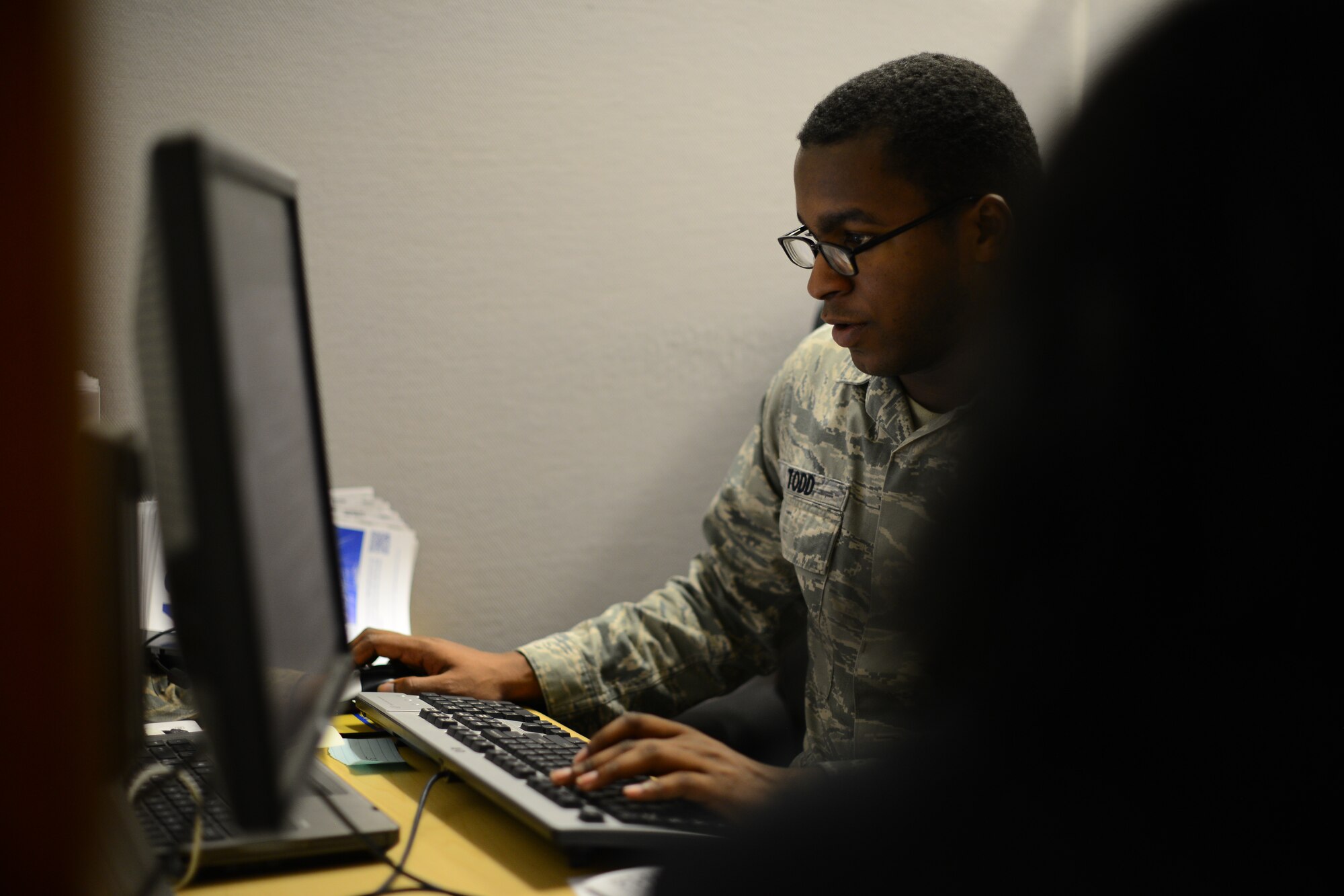 Senior Airman Ameer Todd, McConnell Tax Center volunteer income tax assistant, files a Team McConnell member’s taxes, Feb. 4, 2016, at McConnell Air Force, Kan. McConnell's Tax Center is providing a free tax filing service for military members and their families, retirees and civilians on base from Feb. 1 to April 15. (U.S. Air Force photo/Airman 1st Class Christopher Thornbury)