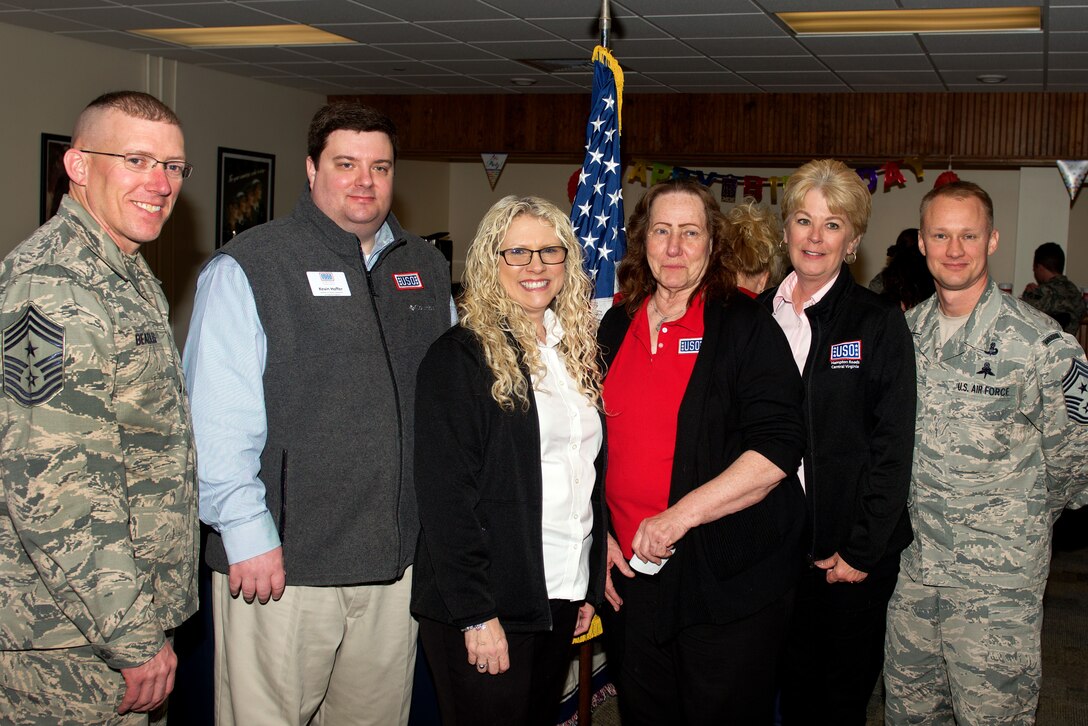 United Service Organization staff, Chief Master Sgt. Ronald Beadles, 1st Fighter Wing command chief, and Chief Master Sgt. Mark Hurst, 633rd Air Base Wing command chief, celebrate during the re-opening of the USO at Langley Air Force Base, Va., Feb. 4, 2016. The center offers a place for Airmen to relax and recharge in the  multipurpose room which provides games, snacks and acts as another venue for various base entities to host events. (U.S. Air Force photo by Airman 1st Class Derek Seifert)
