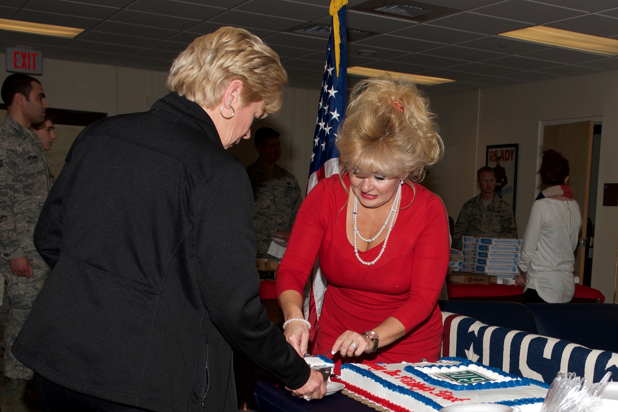 Loretta Knauth, United Service Organization Hampton Roads director of corporate and donor relations, serves cake during the re-opening of the USO at Langley Air Force Base, Va., Feb. 4, 2016. The USO celebrated its 75th anniversary. The center is open Monday-Friday from 9 a.m. to 5 p.m. (U.S. Air Force photo by Airman 1st Class Derek Seifert)