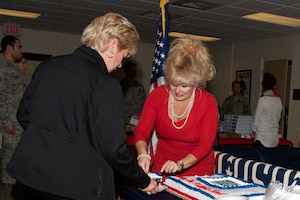 Loretta Knauth, United Service Organization Hampton Roads director of corporate and donor relations, serves cake during the re-opening of the USO at Langley Air Force Base, Va., Feb. 4, 2016. The USO celebrated its 75th anniversary. The center is open Monday-Friday from 9 a.m. to 5 p.m. (U.S. Air Force photo by Airman 1st Class Derek Seifert)