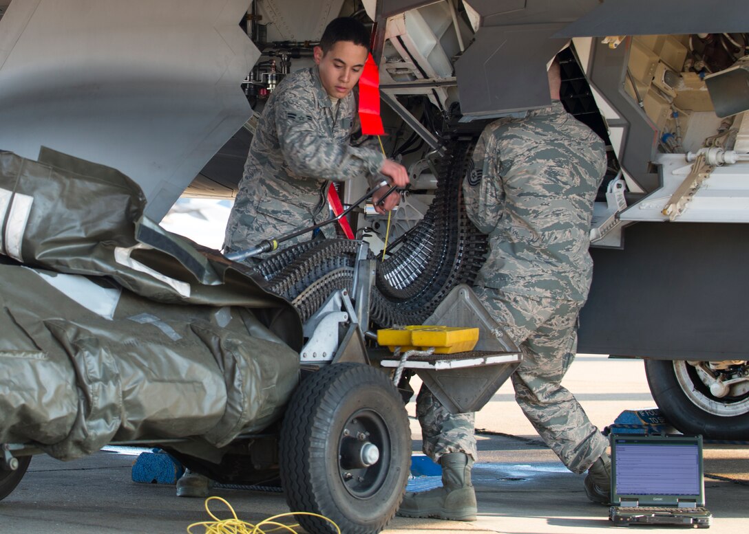 U.S. Air Force Tech. Sgt. Michael Dickens and Airman 1st Class Julian Lopez III, weapons crew members assigned to the 94th Aircraft Maintenance Squadron, load 20 millimeter ammo into an F-22 Raptor during an exercise at Langley Air Force Base, Va., Feb. 2, 2016. Approximately 40 munitions systems specialists from the 94th Aircraft Maintenance Unit will participate in the “94th Banner Ops” event. (U.S. Air Force photo by Staff Sgt. J.D. Strong II/Released)