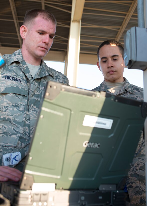 U.S. Air Force Tech. Sgt. Michael Dickens and Airman 1st Class Julian Lopez III, weapons crew members assigned to the 94th Aircraft Maintenance Squadron, analyze their checklist prior to weapons loading at Langley Air Force Base, Va., Feb. 2, 2016.The munitions systems specialists will provide weapons support to sustain pilots’ annual weapons proficiency training during the “94th Banner Ops” event. (U.S. Air Force photo by Staff Sgt. J.D. Strong II/Released)