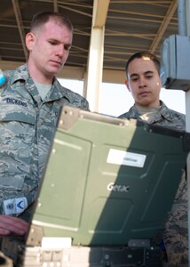 U.S. Air Force Tech. Sgt. Michael Dickens and Airman 1st Class Julian Lopez III, weapons crew members assigned to the 94th Aircraft Maintenance Squadron, analyze their checklist prior to weapons loading at Langley Air Force Base, Va., Feb. 2, 2016.The munitions systems specialists will provide weapons support to sustain pilots’ annual weapons proficiency training during the “94th Banner Ops” event. (U.S. Air Force photo by Staff Sgt. J.D. Strong II/Released)
