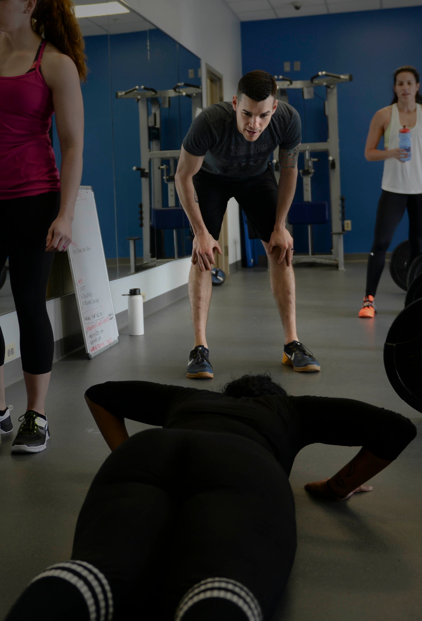 Volunteer coach Tech. Sgt. Kyle Douglass, a flight chief assigned to the 91st Missile Security Forces Squadron, motivates an athlete in the beginner’s tactical fitness class, OnRamp, at the McAdoo Fitness Center Feb. 4, 2016. OnRamp focuses on form and mechanics for athletes with no prior tactical fitness experience. (U.S. Air Force photo/Airman 1st Class Jessica Weissman)