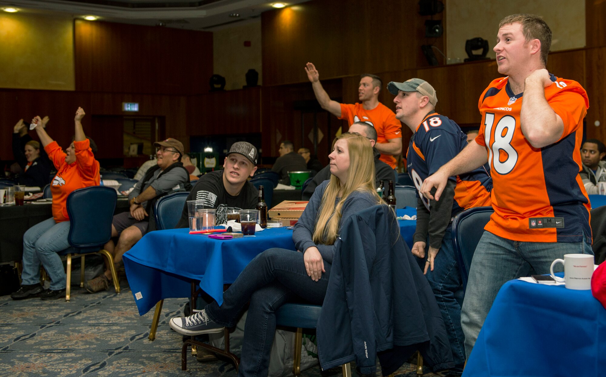 Denver Broncos fans cheer during National Football League’s 50th Super Bowl screening in Club Eifel at Spangdahlem Air Base, Germany, Feb. 8, 2016. The Broncos defeated the Carolina Panthers with a final score of 24 - 10. (U.S. Air Force photo by Airman 1st Class Timothy Kim/Released)