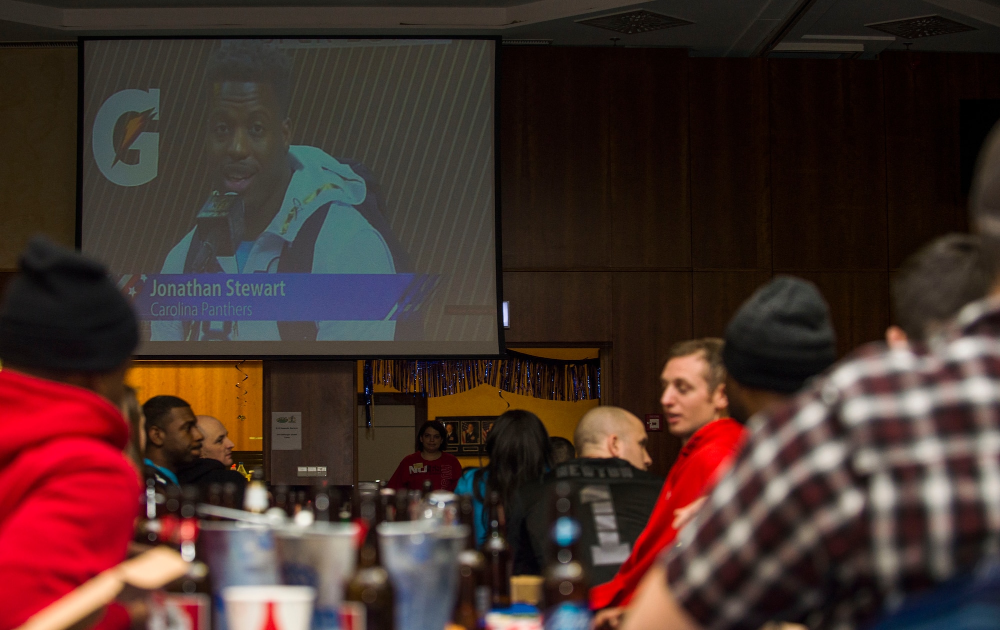 Spangdahlem community members watch coverage of the National Football League’s 50th Super Bowl during a screening in Club Eifel at Spangdahlem Air Base, Germany, Feb. 8, 2016. The event included food service, beverages and a raffle. (U.S. Air Force photo by Airman 1st Class Timothy Kim/Released)