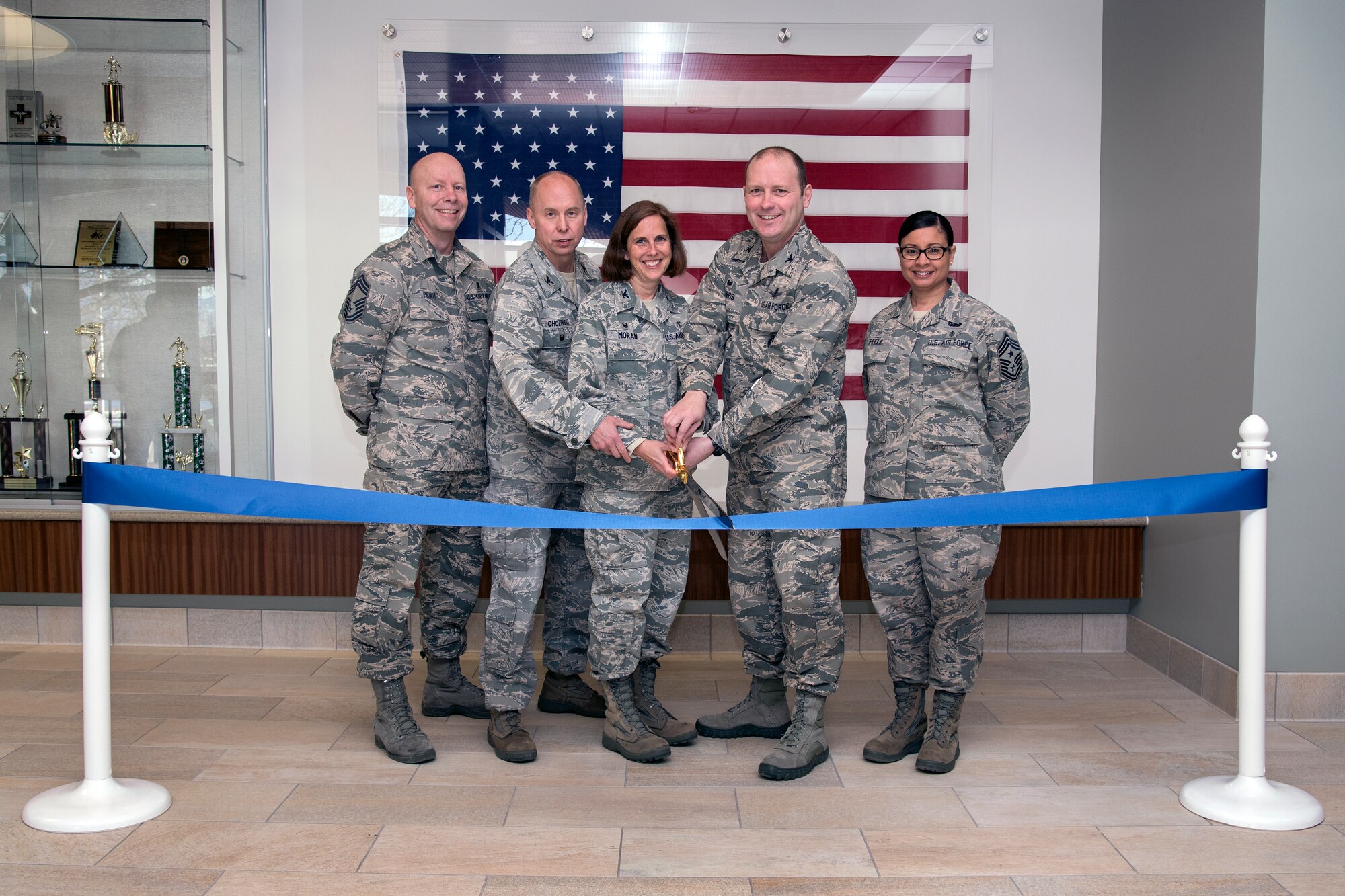 PETERSON AIR FORCE BASE, Colo. - From left, Chief Master Sergeant Jack D. Pruitt, 21st Medical Group superintendent, Col. Joseph P. Chozinski, U.S. Air Force Space Command surgeon general, Col. Susan O. Moran, 21st Medical Group commander, Col. Douglas A. Schiess, 21st Space Wing commander and Chief Master Sergeant Idalia A. Peele, 21st Space Wing command chief participate in the 21st Medical Group Ribbon Cutting Ceremony. The ceremony was held to publicize the 21st Medical Group accomplishments and completion of the $18 Million medical clinic realignment project.  The new renovations included the main clinic and the clinic annex. (U.S. Air Force photo by Craig Denton)

